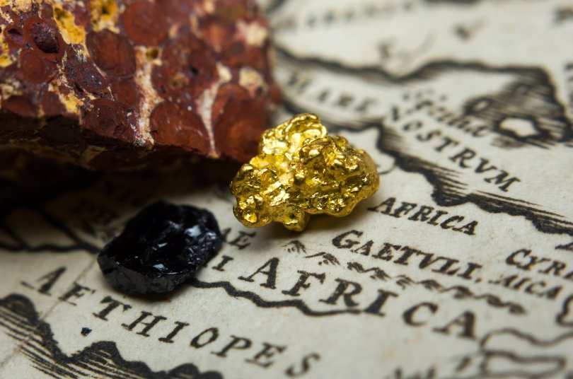 Close-up of minerals (gold, bauxite and coal) on a map of africa