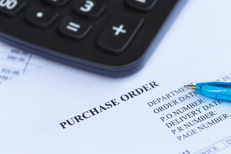purchase order with pen and calculator in the office